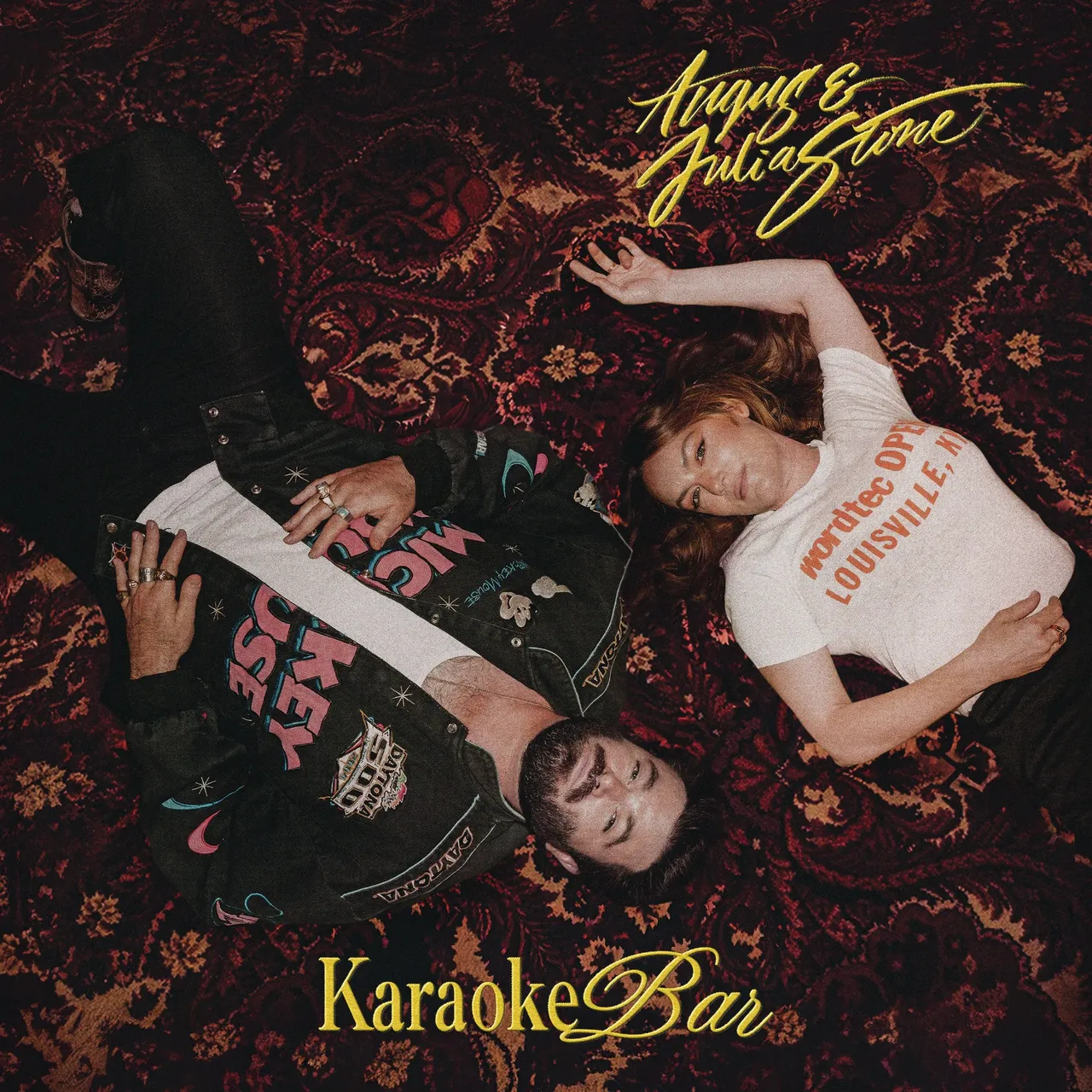 Album cover for Karaoke Bar by Angus and Julia Stone featuring the duo lying on an ornate patterned rug.