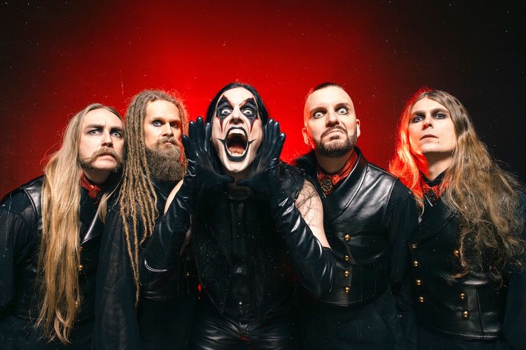 Swedish metal band Avatar posing against a red backdrop, featuring frontman Johannes Eckerström in clown makeup with hands raised shouting.