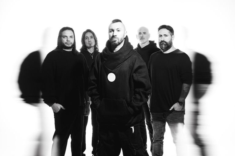 Black and white promotional photo of progressive metal band Periphery standing together against a white studio backdrop.