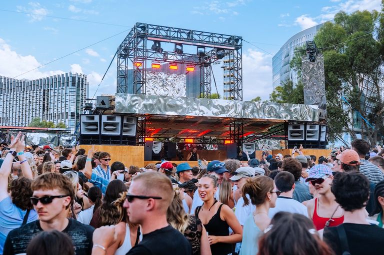Crowd dancing in front of an outdoor stage setup at Sidebyside festival in Adelaide.