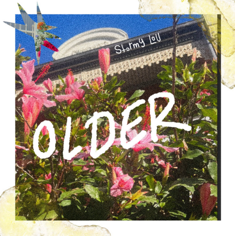Single cover artwork for Stormy-Lou's track Older, featuring pink flowers in front of a building with handwritten title text overlay.