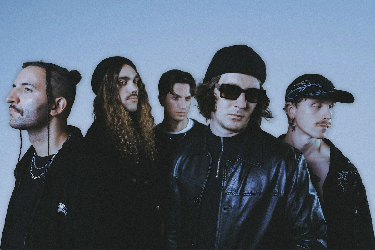 Press photo of Australian metalcore band Windwaker posing in dark streetwear against a cool blue background.