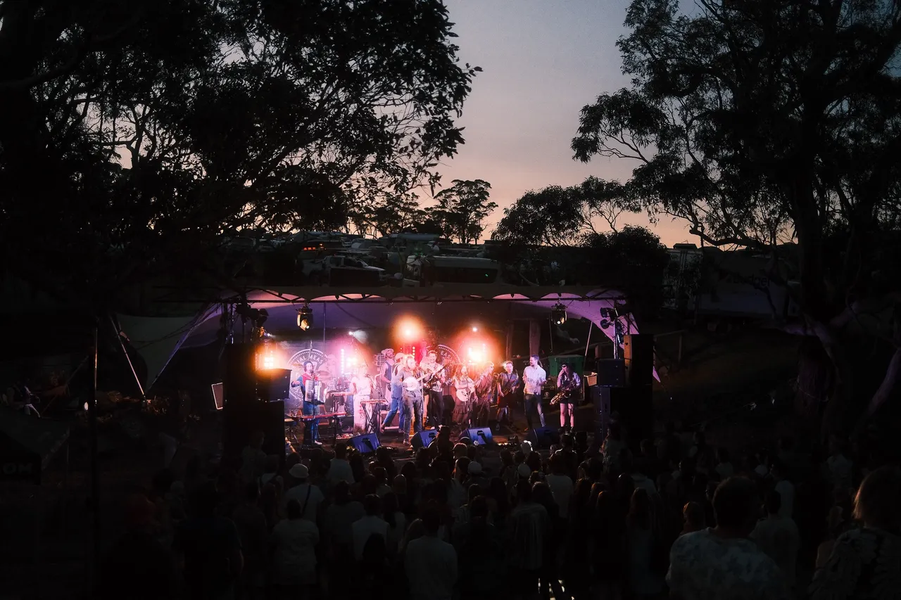 Folk band Bromham performing live on stage at sunset before a crowd at Space Jams Festival 2025.